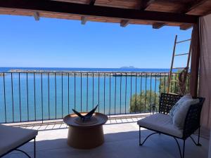 a balcony with a view of the water at Moonstone Seafront Suite in Kokkinos Pirgos