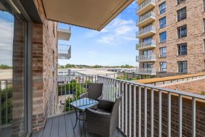 a balcony with two chairs and a table at Stylish 1-Bed flat with Private Balcony in Hatch End