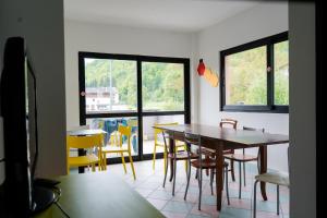 a dining room with a table and chairs at Valsesia Hostel in Scopello