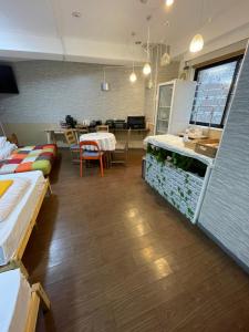 a room with a restaurant with a table and chairs at Shinjuku Sky hostel in Tokyo