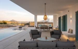 a living room with a couch and a table at Alkinoe Villa Paros in Isterni