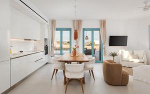a kitchen and living room with a table and chairs at Alkinoe Villa Paros in Isterni +53 photos