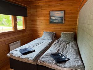 a bedroom with two beds in a log cabin at Villa Predium renovated cottage for four in Raseborg