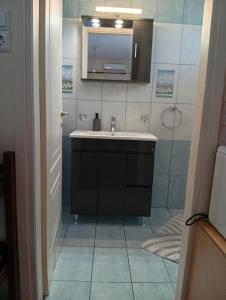 a bathroom with a sink and a shower at Kalivakia View in Tsoukalades +39 photos