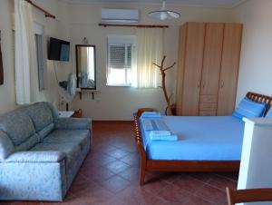 a living room with a couch and a bed at Kalivakia View in Tsoukalades