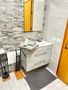 a bathroom with a sink and a mirror at Villa Trevisi - ROOMS -free parking in Treviso +36 photos
