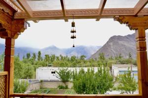 a view of the mountains from a window of a building at Lavender House in Nubra +16 photos