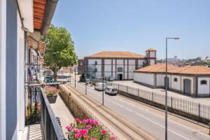 a view from a balcony of a street with flowers at Miragaia - Riverside Suites - Adults Only in Porto