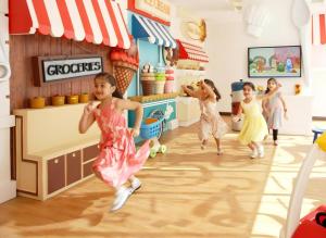 a group of young girls running in a store dancing at Sedra Al Alami Jeddah in Jeddah