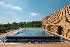 a swimming pool on the deck of a house at ARTEVINI Resort & Winery in Velké Pavlovice