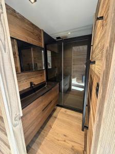 a bathroom with a shower and a sink at Splendide châlet neuf avec jaccuzzi in Bolquere Pyrenees 2000 +27 photos