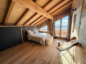 a bedroom with a bed and a large window at Splendide châlet neuf avec jaccuzzi in Bolquere Pyrenees 2000