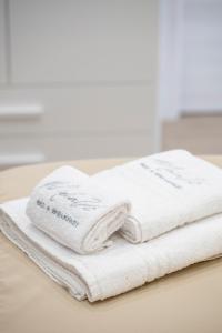 two white towels sitting on top of a table at B&B Melavì in Lizzano