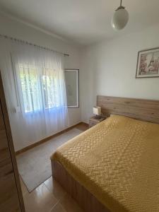 a bedroom with a large bed and a window at Fortress Apartment in Bar
