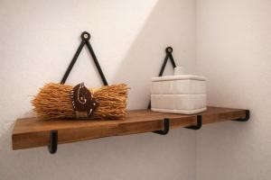 a wooden shelf with hay and a white appliance on it at Tite Case Désirée in Petite Île