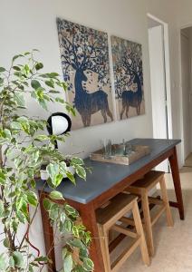 a table in a room with paintings on the wall at Independent and comfortable room in Arrens-Marsous