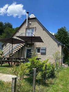 a house with an umbrella in front of it at Independent and comfortable room in Arrens-Marsous