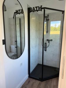 a bathroom with a shower with a mirror at Domek letniskowy in Kolno +32 photos