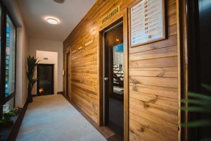 a hallway with wooden walls and a door at Hotel Spa & Events Imperial Sighișoara in Sighişoara +30 photos
