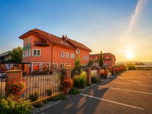 a house with a fence in a parking lot at Hotel Evan u Hoffera with free parking in Topoľčany