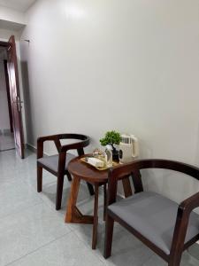 a wooden table with two chairs and a telephone at J&Q Hotel in Sihanoukville +5 photos