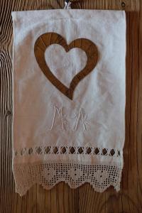 a napkin with a heart on it on a table at B&B Borgo Saint-Rhémy in Saint-Rhémy-en-bosses