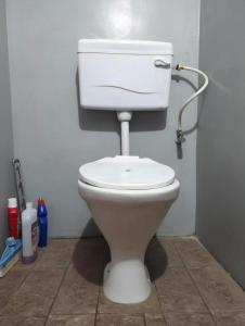 a bathroom with a white toilet in a room at Anigo 3bhk, Itanagar in Itānagar +3 photos