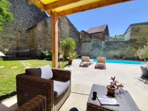 an outdoor patio with a couch and a table at Villa Modéliacus in Meuilley