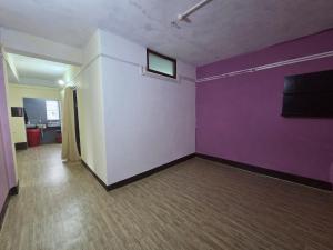 an empty room with purple and white walls at Anigo 3bhk, Itanagar in Itānagar