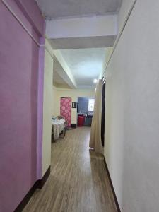 a hallway with a room with purple walls and a table at Anigo 3bhk, Itanagar in Itānagar