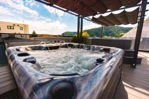 a hot tub on the roof of a house at Hotel Spa & Events Imperial Sighișoara in Sighişoara