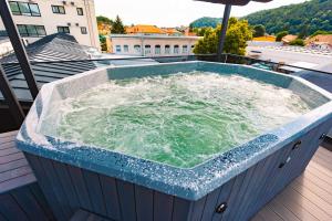 a hot tub on the roof of a building at Hotel Spa & Events Imperial Sighișoara in Sighişoara