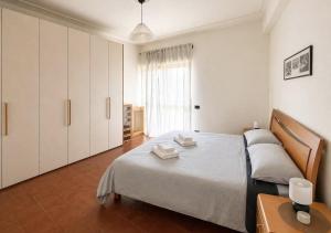 a bedroom with a bed and a table and a window at Rome Home Cinecittà in Rome