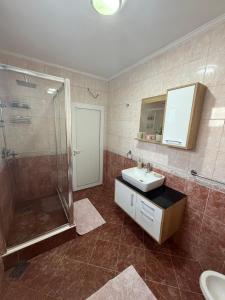 a bathroom with a shower and a sink and a mirror at Fortress Apartment in Bar +24 photos
