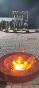 a fire pit in the middle of a courtyard at Tridalam Resort in Bangalore