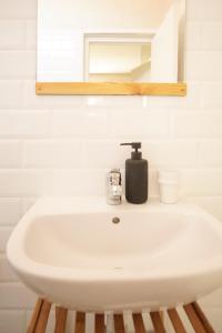 a bathroom sink with a soap dispenser on it at The Line Up in Mirleft