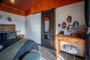 a bedroom with a bed and a fireplace at Matilo Cabins - Cactus Deck with Hot-tub and Fireplace in Calitzdorp