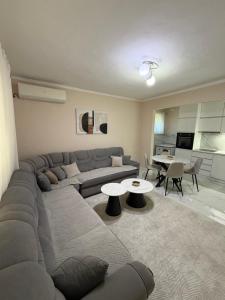 a living room with a couch and a table at Fortress Apartment in Bar