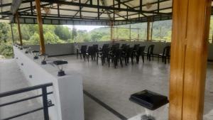a large room with black chairs and a table at Silver Valley Villas in Yercaud