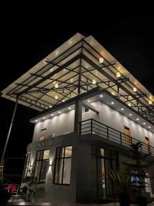 a large building with lights on top of it at night at Silver Valley Villas in Yercaud