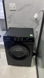 a black appliance sitting on top of a washing machine at Lishome My Khe Beach Apartment - An Thuong in Danang