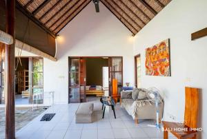 a living room with a couch and a table at villa TOYA NING in Ungasan