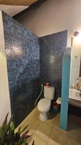 a bathroom with a toilet and a sink at villa TOYA NING in Ungasan +9 photos