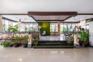 a lobby of a restaurant with plants at Atanaya Kuta Bali in Kuta +65 photos