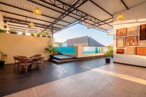a large room with a table and chairs and a building at Atanaya Kuta Bali in Kuta