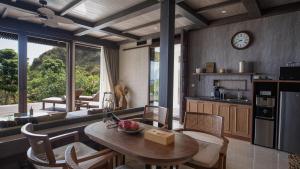 a kitchen and dining room with a table and chairs at Plataran Komodo Resort & Spa - CHSE Certified in Labuan Bajo