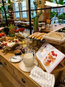 a buffet of food on a table with bread and pastries at Saman Hotel Boutique in Valencia