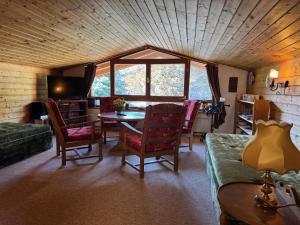 a living room with a table and chairs and a window at Appartementhaus Grocke in Wagrain