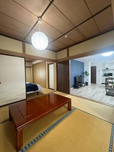 a bedroom with a bed and a table in a room at Guest house LIA1 in Abashiri