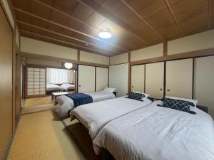 a room with two beds in a room at Guest house LIA1 in Abashiri